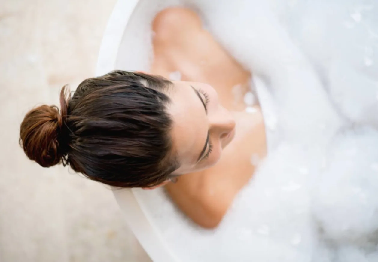 woman taking bubble bath spa day at home concept